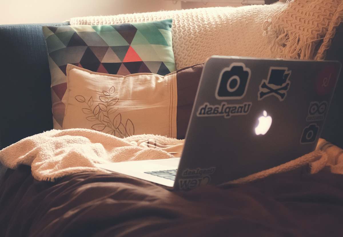 college place MacBook Air on top of sofa home decor